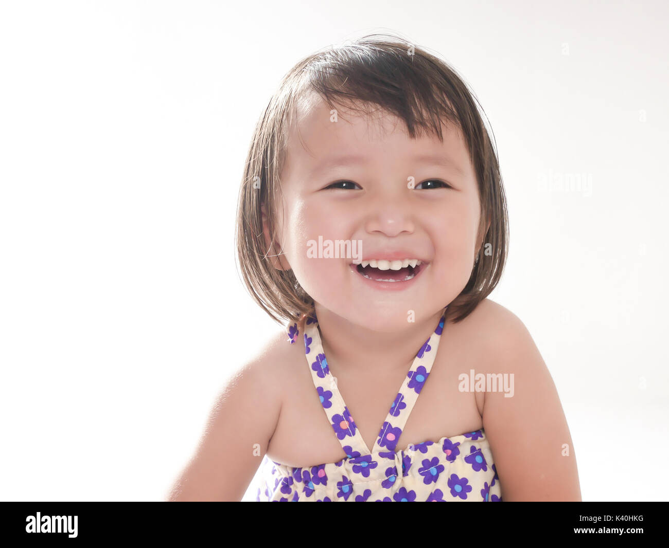 Portrait of 2 year old little girl , Smiling face on bright white background Stock Photo