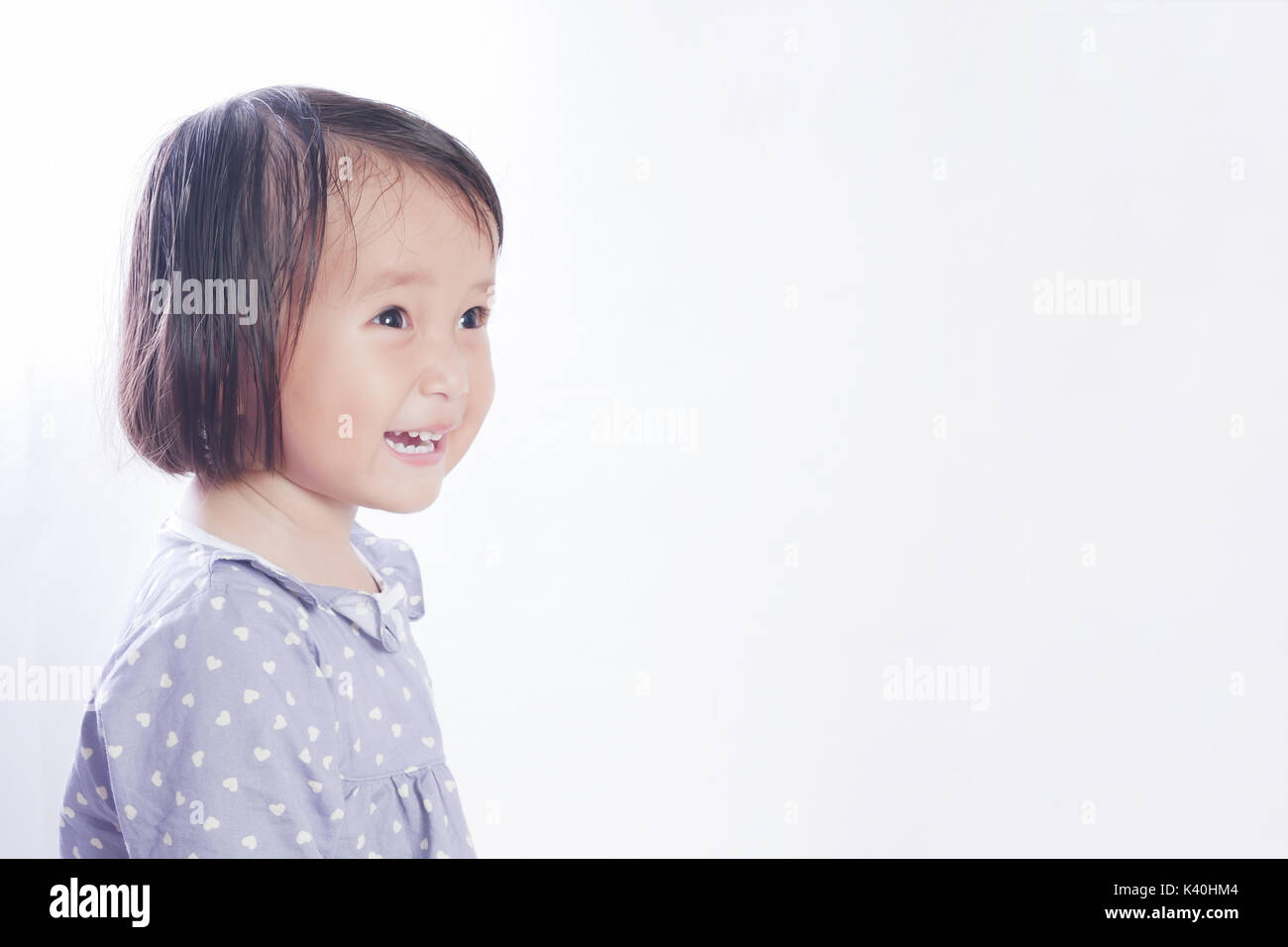 Portrait of 2 year old little girl , Smiling face on bright white background Stock Photo
