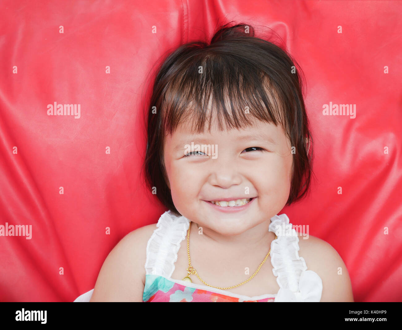 Smiling Little girl with something is stucking in teeth Stock Photo