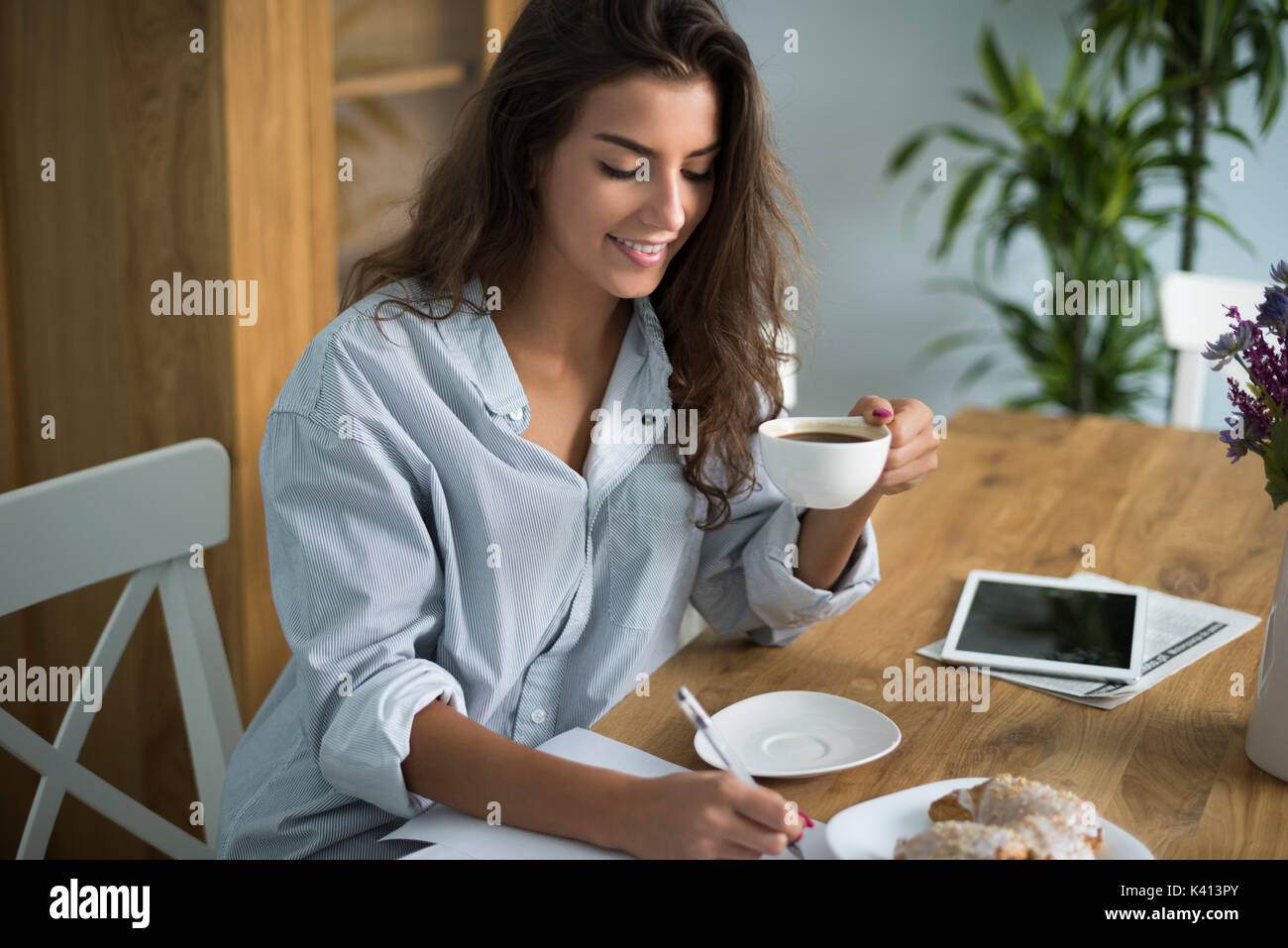 She is always a hardworker, even in the morning Stock Photo