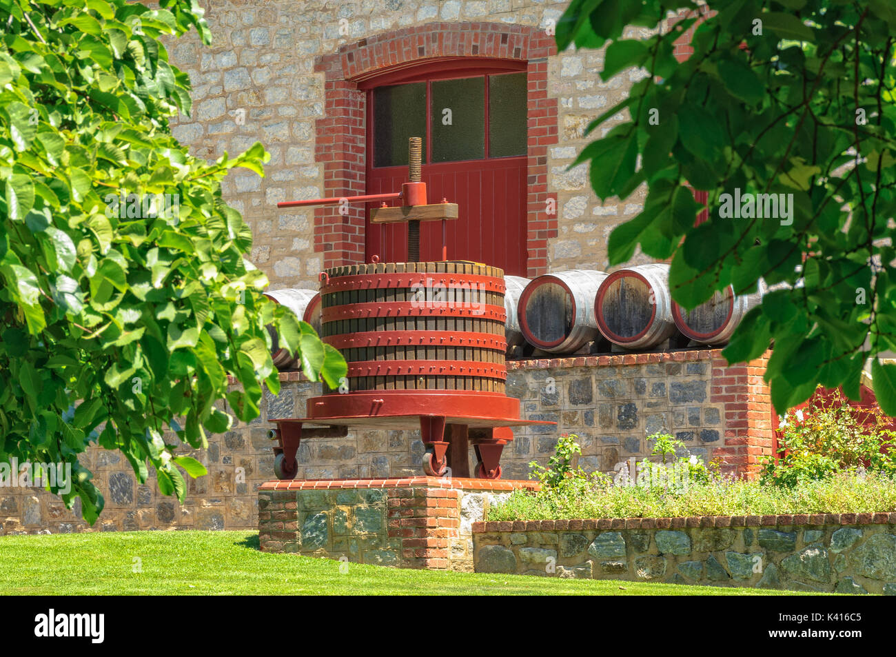 Grape press and barrels in front of a cellar door of Yalumba Winery in