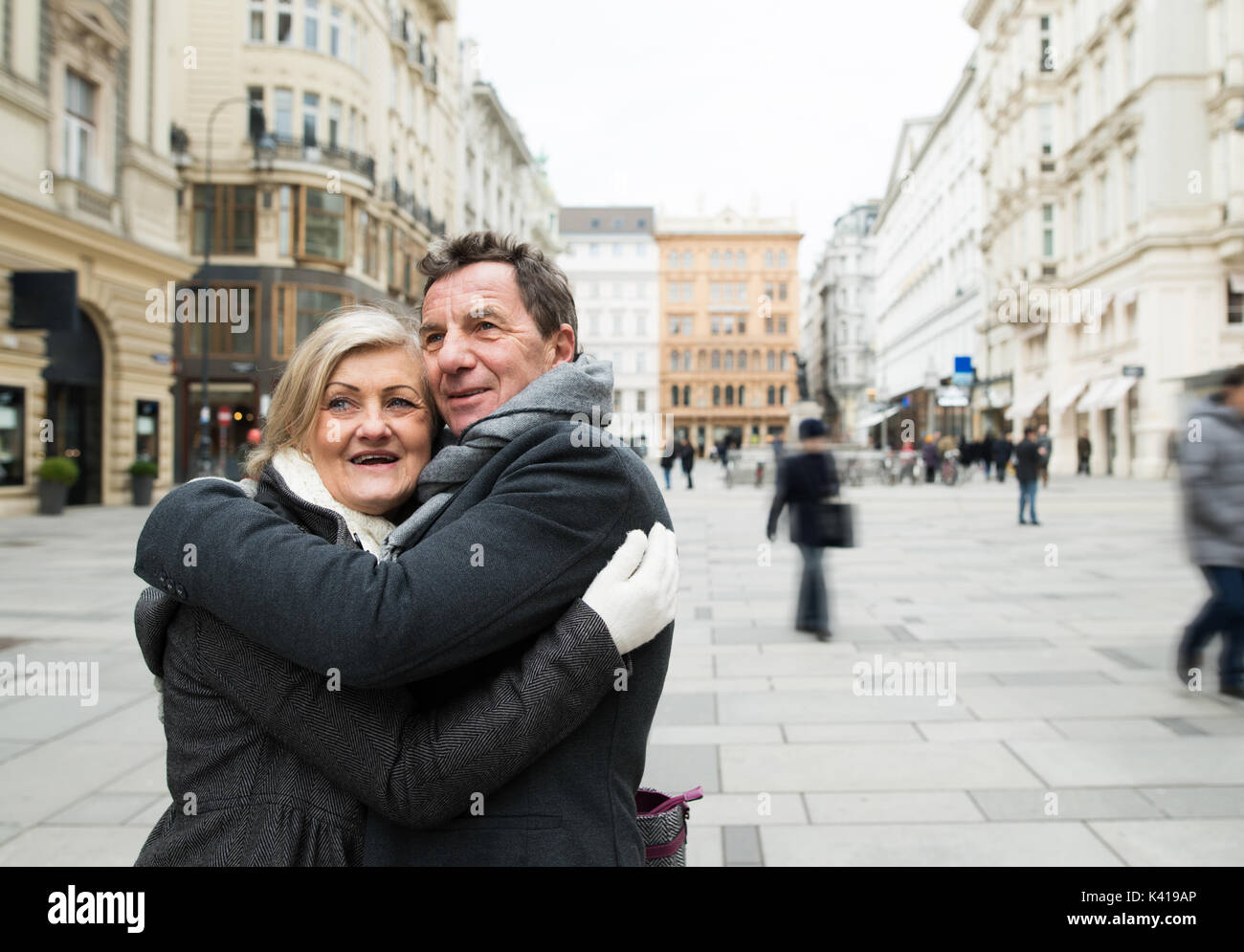 Senior couple on a walk in city centre. Winter Stock Photo