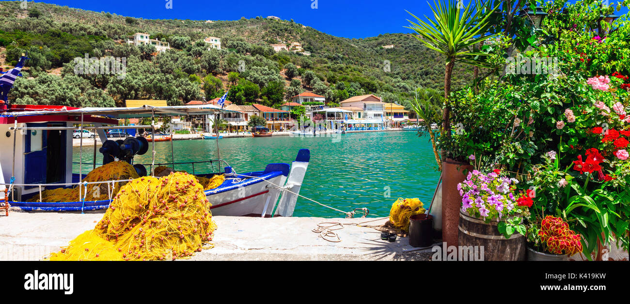 Pictorial Sivota village,view with fishing boat,flowers and sea,Lefkada,Greece. Stock Photo