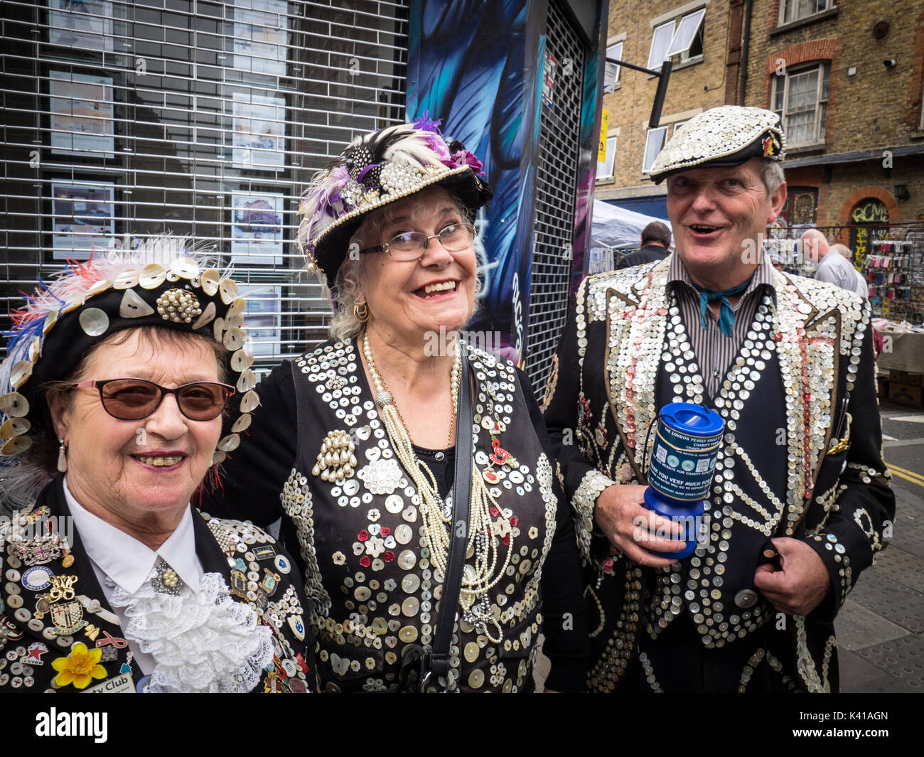 London Pearly Kings and Queens collect money for Charity on Sunday mornings in London's popular Brick Lane market in Spitalfields, East End, London UK Stock Photo