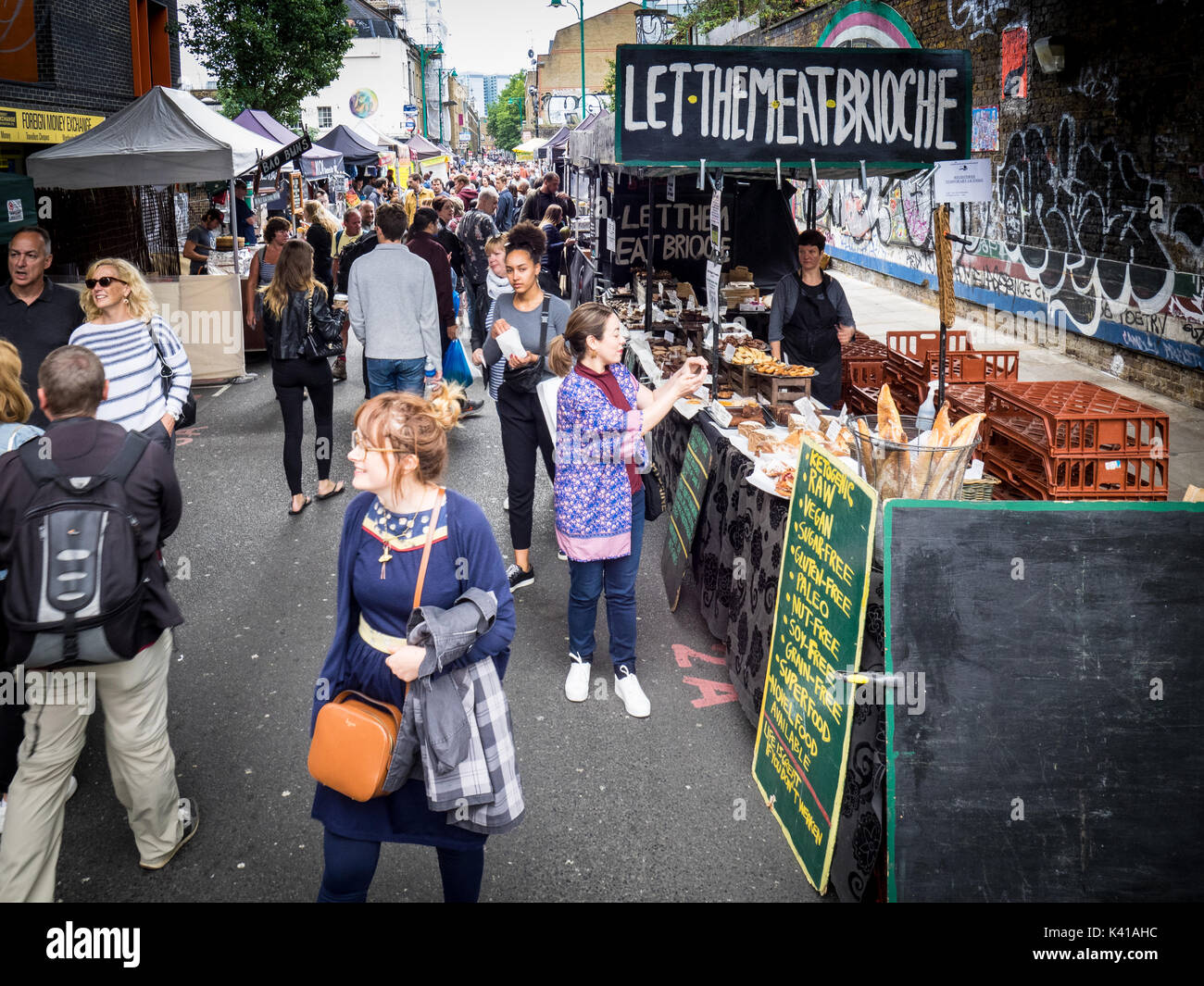 Brick Lane Sunday Food Market - tourists & locals browse the street food stalls in Brick Lane in London's East End on a Sunday morning Stock Photo