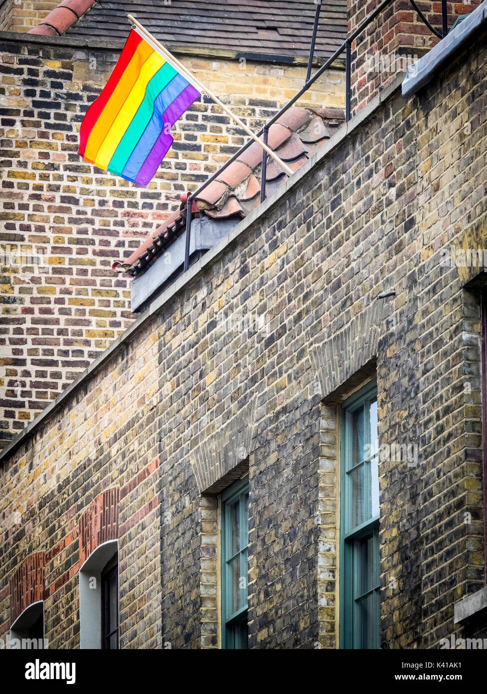 LGBT rainbow flag flies from a building in Spitalfields in London's East End. Stock Photo