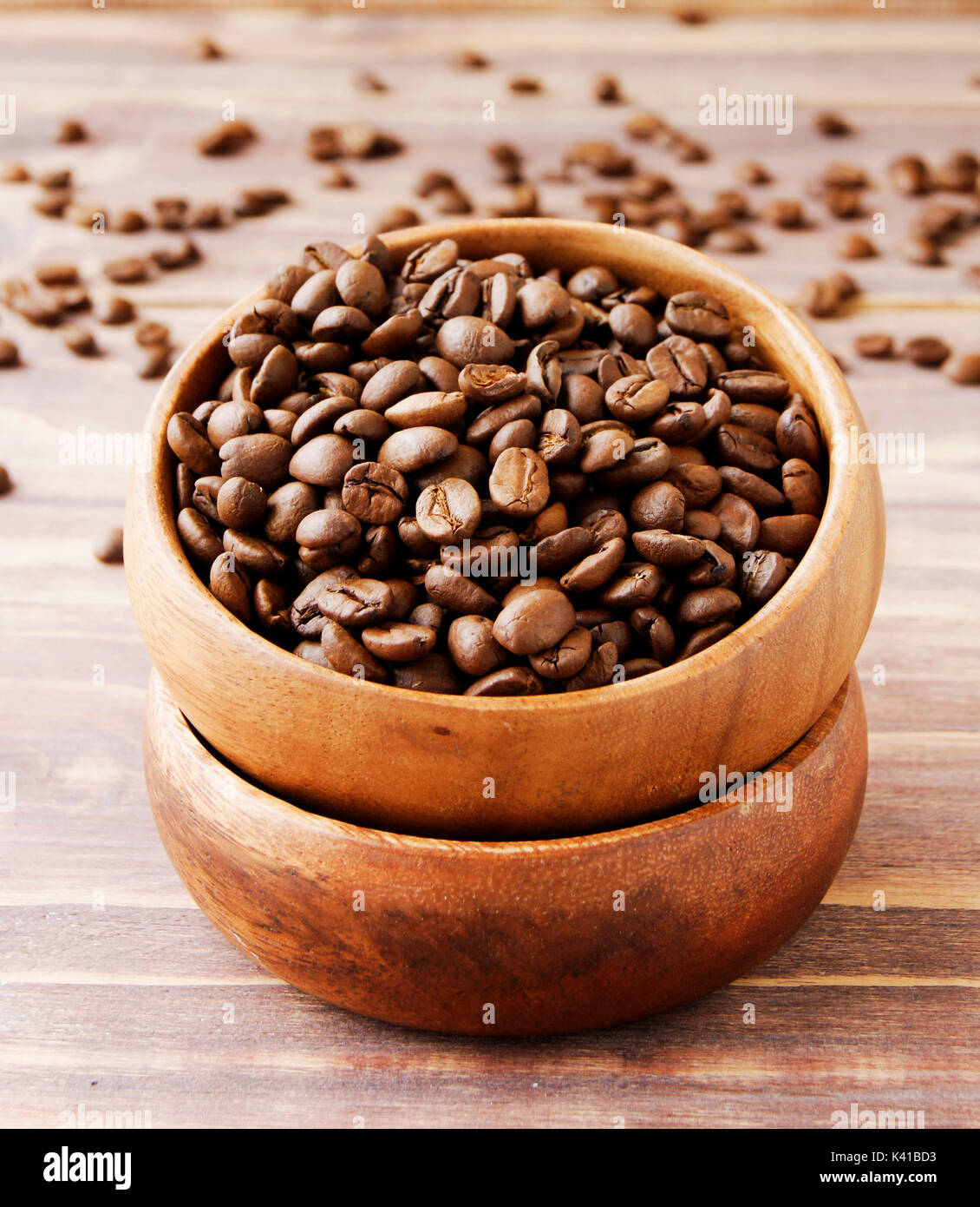 coffee beans in a wooden bowl with a canvas bag, scissors and thread on a wooden table, selective focus Stock Photo