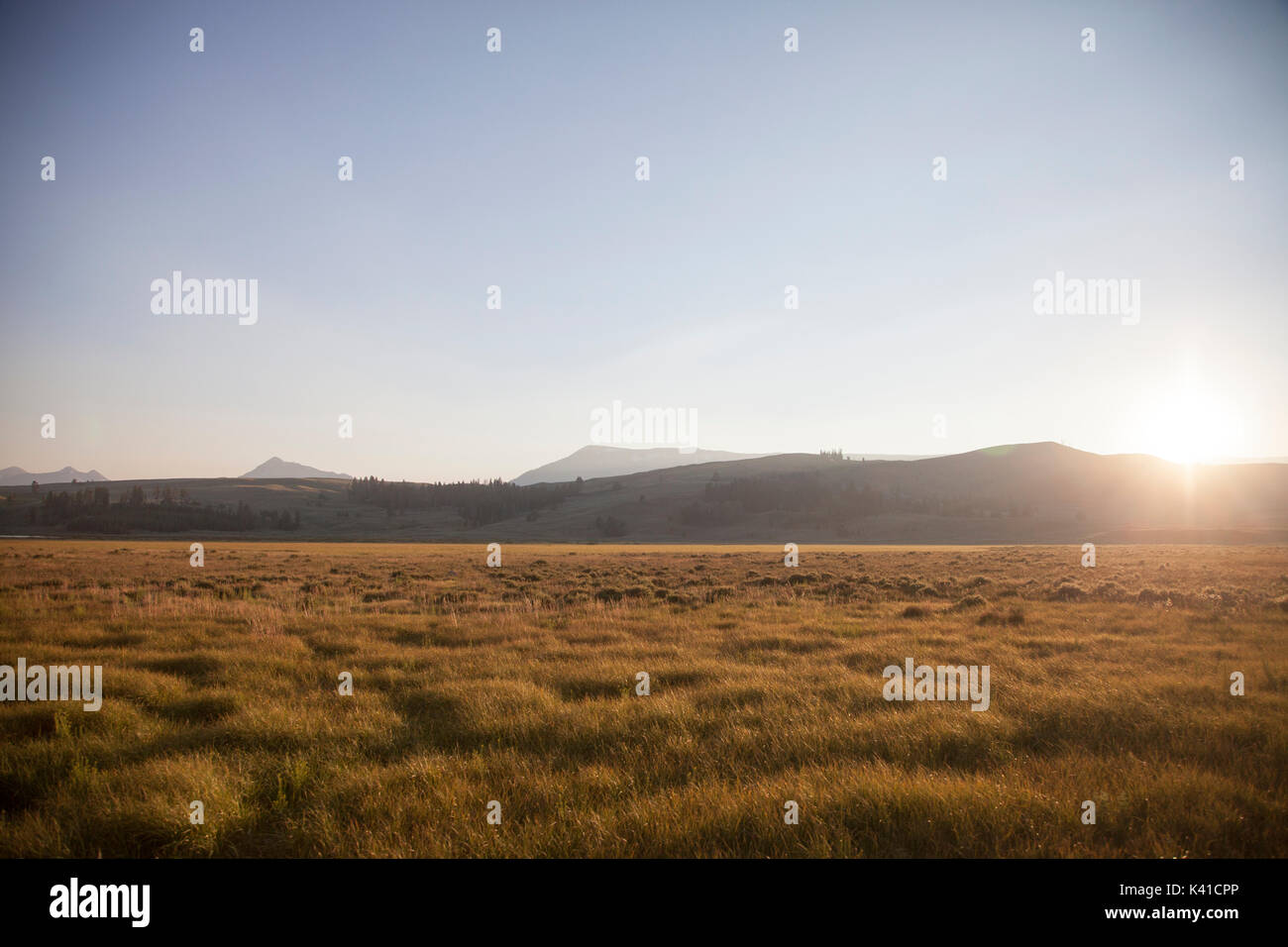 Beautiful sunset with sunrays behind the clouds Stock Photo
