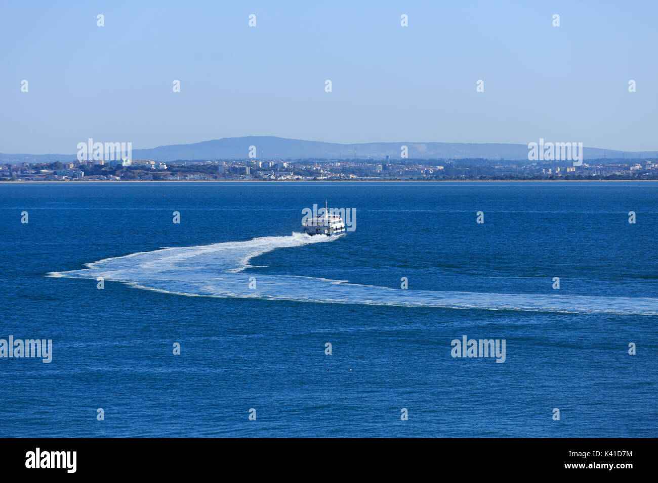 Blue and White Ferry Cruising Away in Lisbon Stock Photo