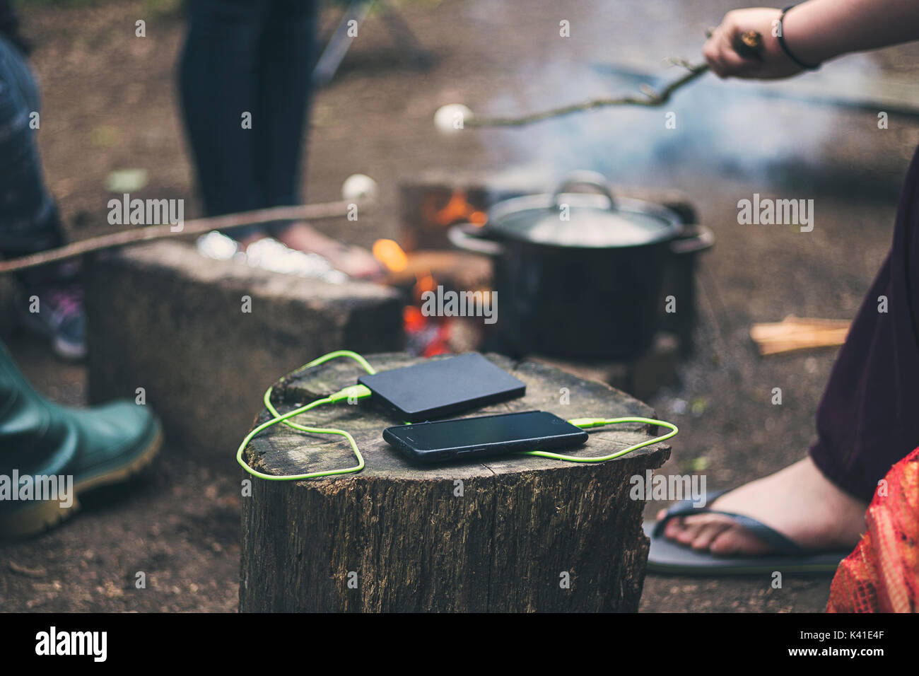 Charging Smartphone by Campfire Stock Photo