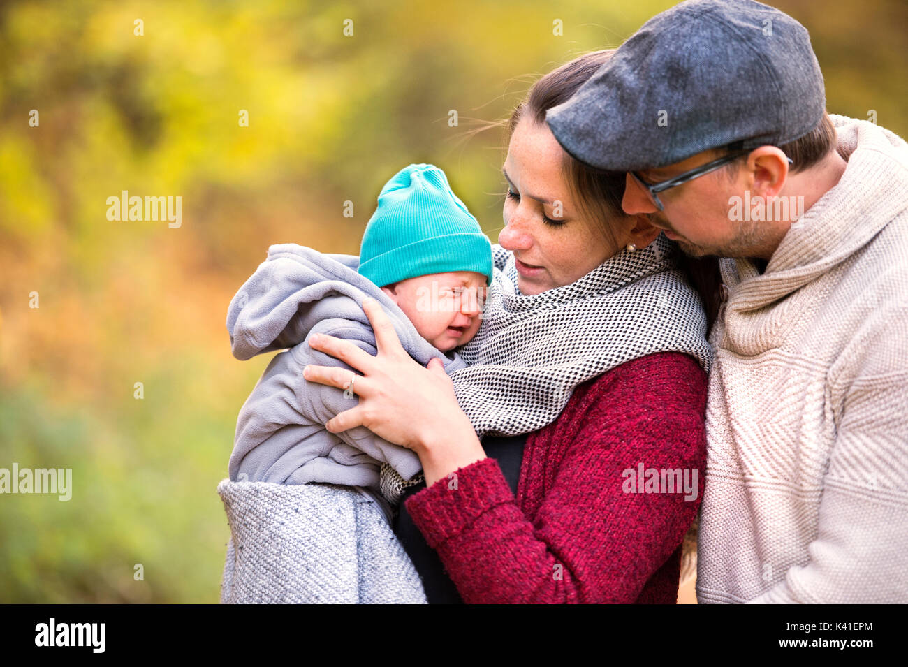 Beautiful young family on a walk in autumn forest Stock Photo - Alamy