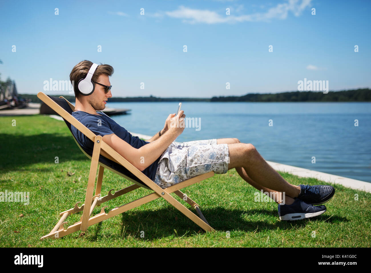 Young man sitting chair lake hi-res stock photography and images - Alamy