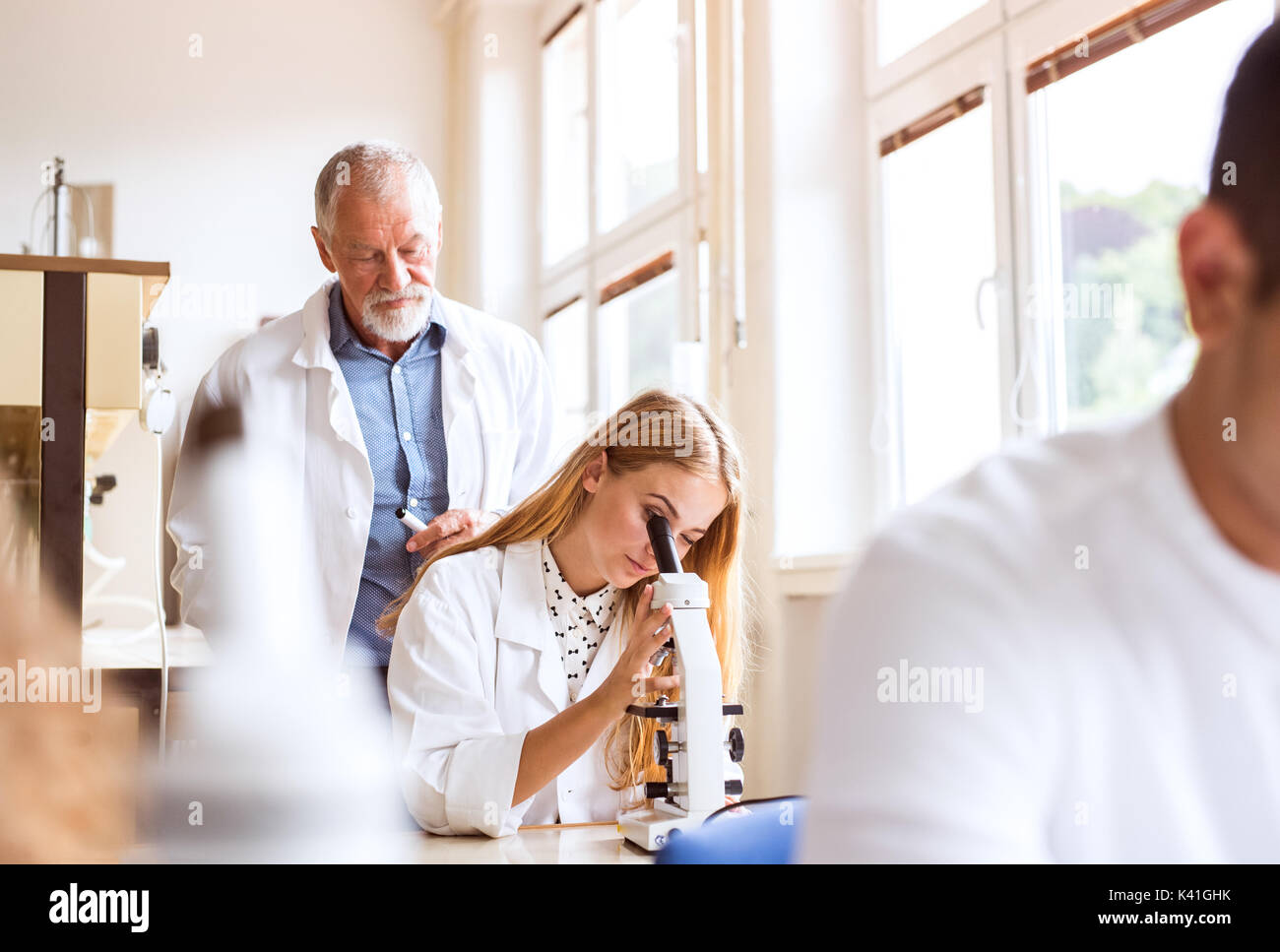 Senior teacher teaching biology to high school student. Stock Photo