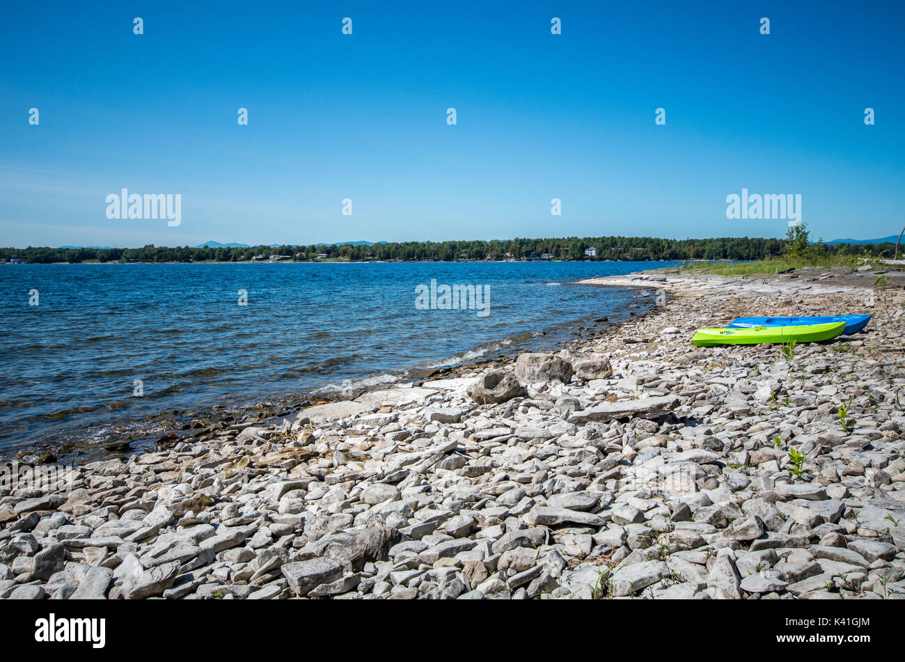 View of the rocky shoreline with kayaks on Valcour island, Peru New York Stock Photo