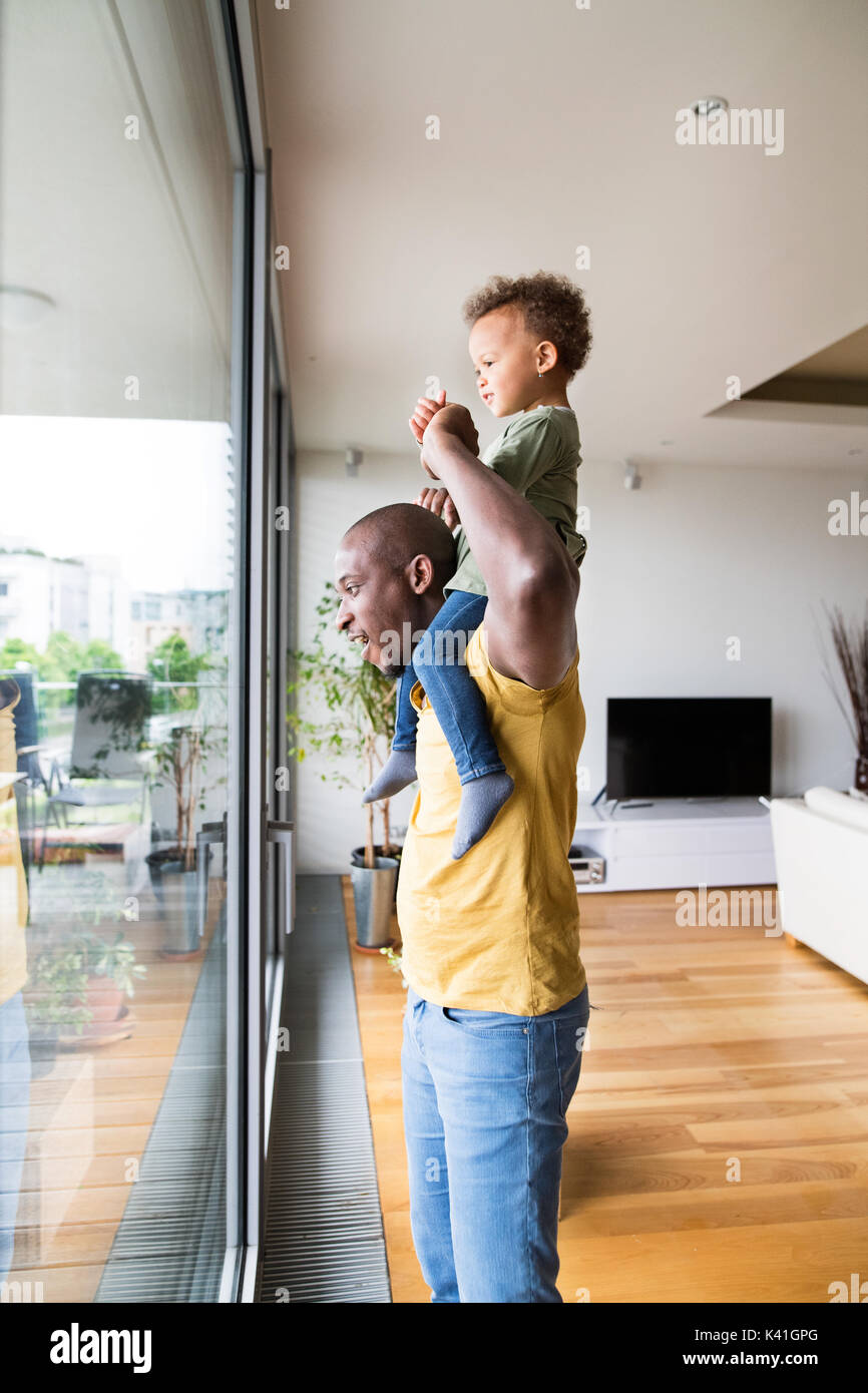 Young afro-american father with his little daughter at home. Stock Photo
