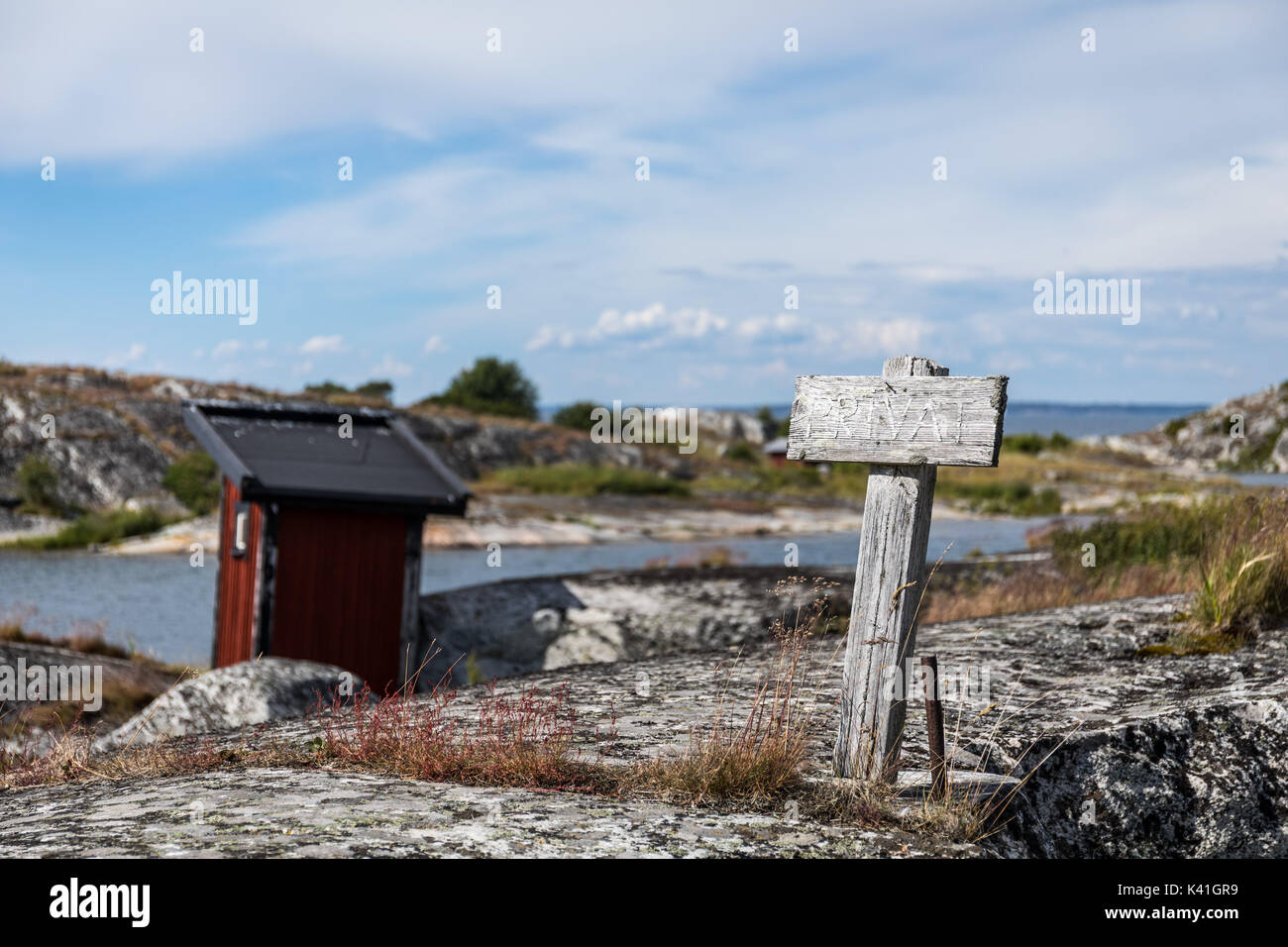 An old weatherbeaten warning sign with the text private tells people to stay away on an island in the Stockholm archipelago Stock Photo