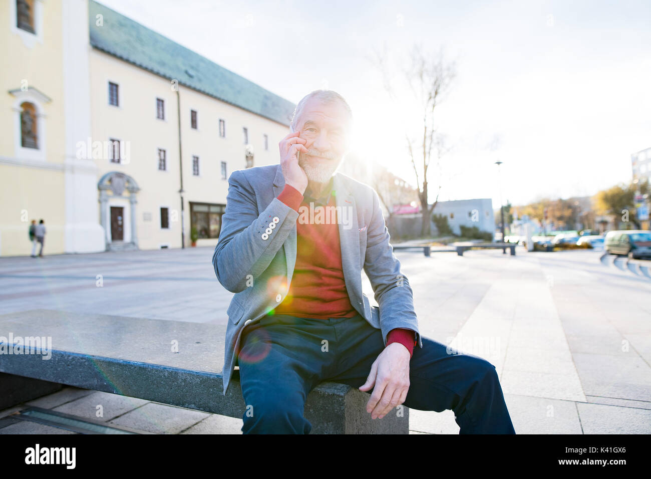 Senior man in town with smart phone, making phone call Stock Photo