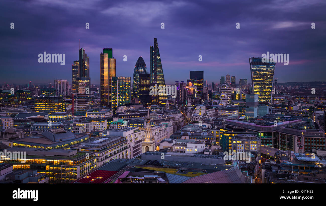 London, England - Panoramic skyline view of Bank district of London with the skyscrapers of Canary Wharf at the background at blue hour Stock Photo