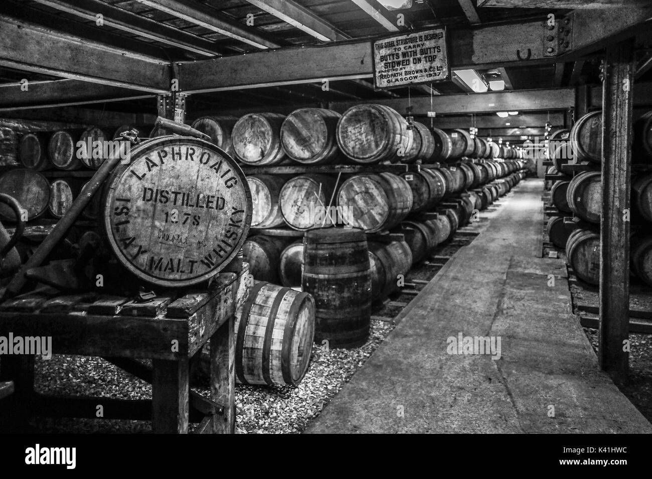 Black and white image of whisky maturing in barrels at the renowned Laphroaig Distillery, Isle of Islay, Scotland Stock Photo