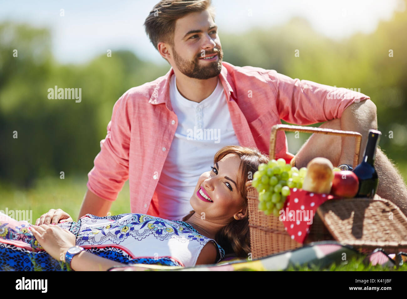 A photo of young, happy couple relaxing on the picnic at the park Stock ...