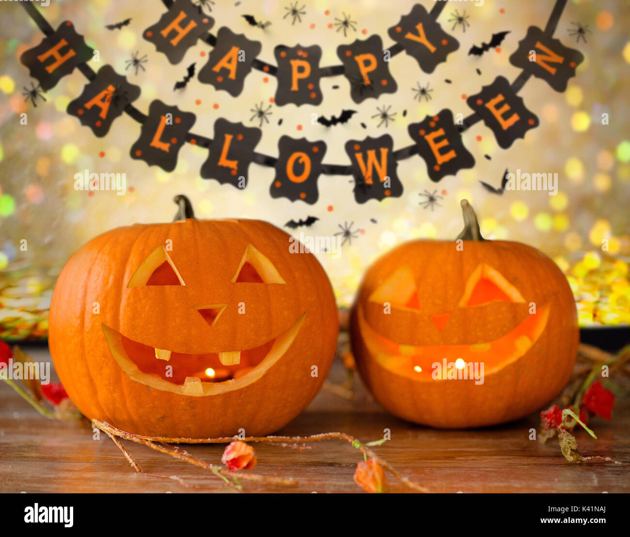 carved pumpkins and happy halloween garland Stock Photo