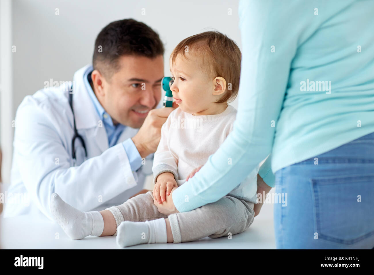 doctor with otoscope checking baby ear at clinic Stock Photo Alamy