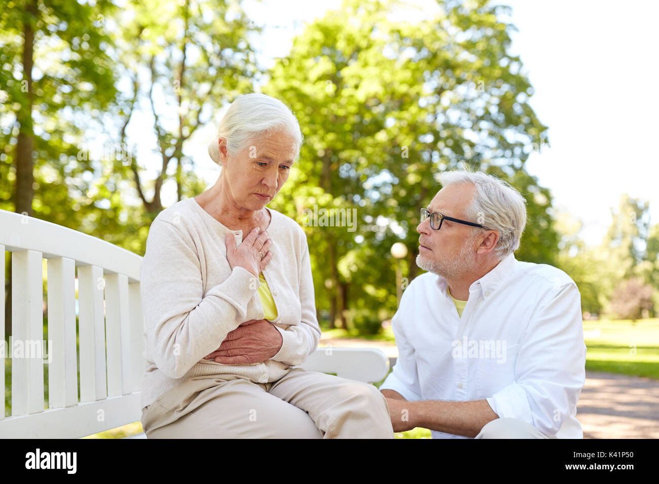 senior woman feeling sick at summer park Stock Photo