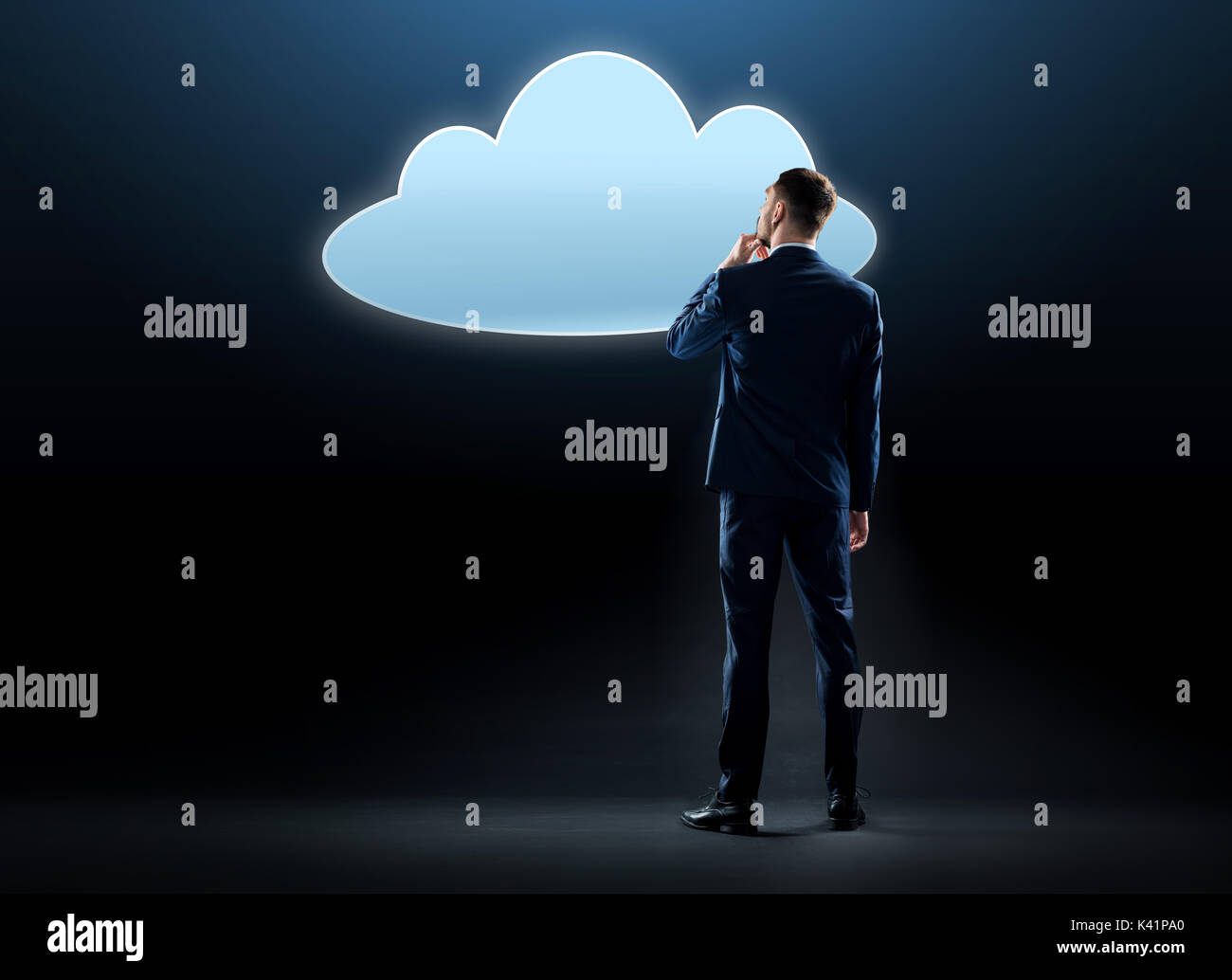 businessman looking at virtual cloud hologram Stock Photo