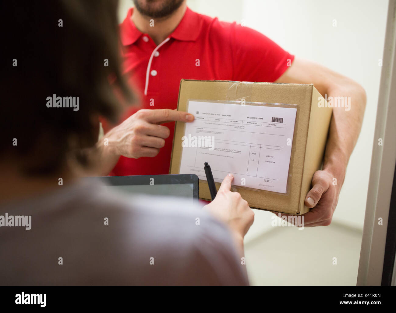 delivery man with box, tablet pc and customer Stock Photo