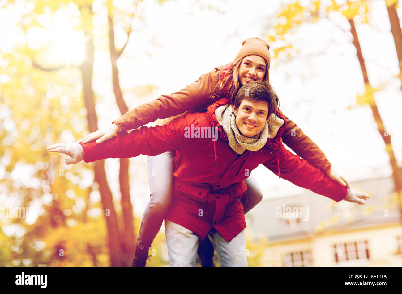 happy young couple having fun in autumn park Stock Photo - Alamy