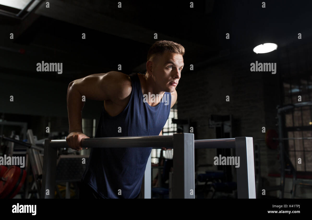 man doing triceps dip on parallel bars in gym Stock Photo Alamy