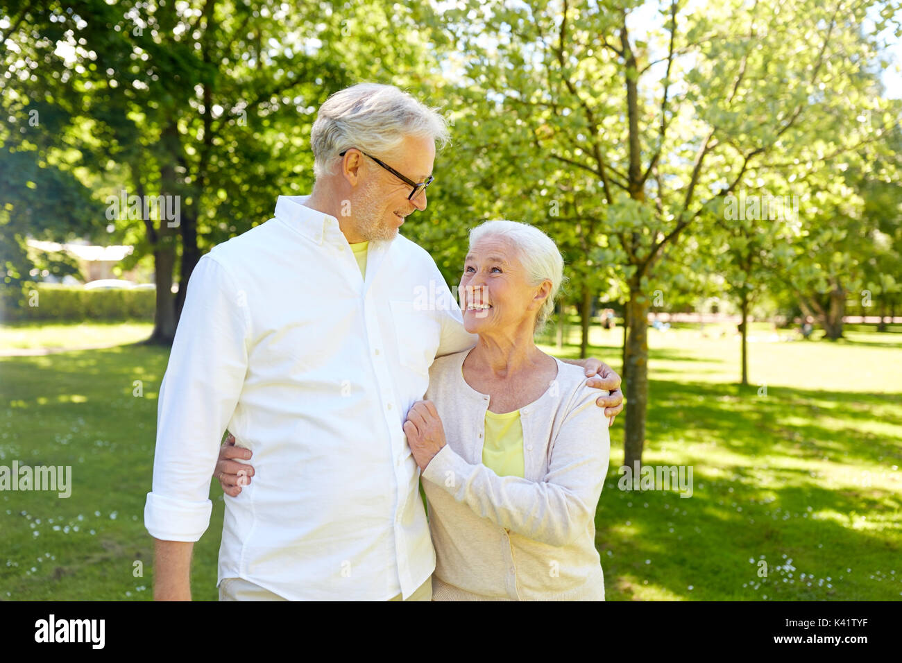 happy senior couple hugging in city park Stock Photo - Alamy