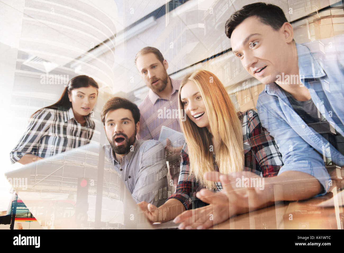 Surprised young colleagues using laptop in the office Stock Photo