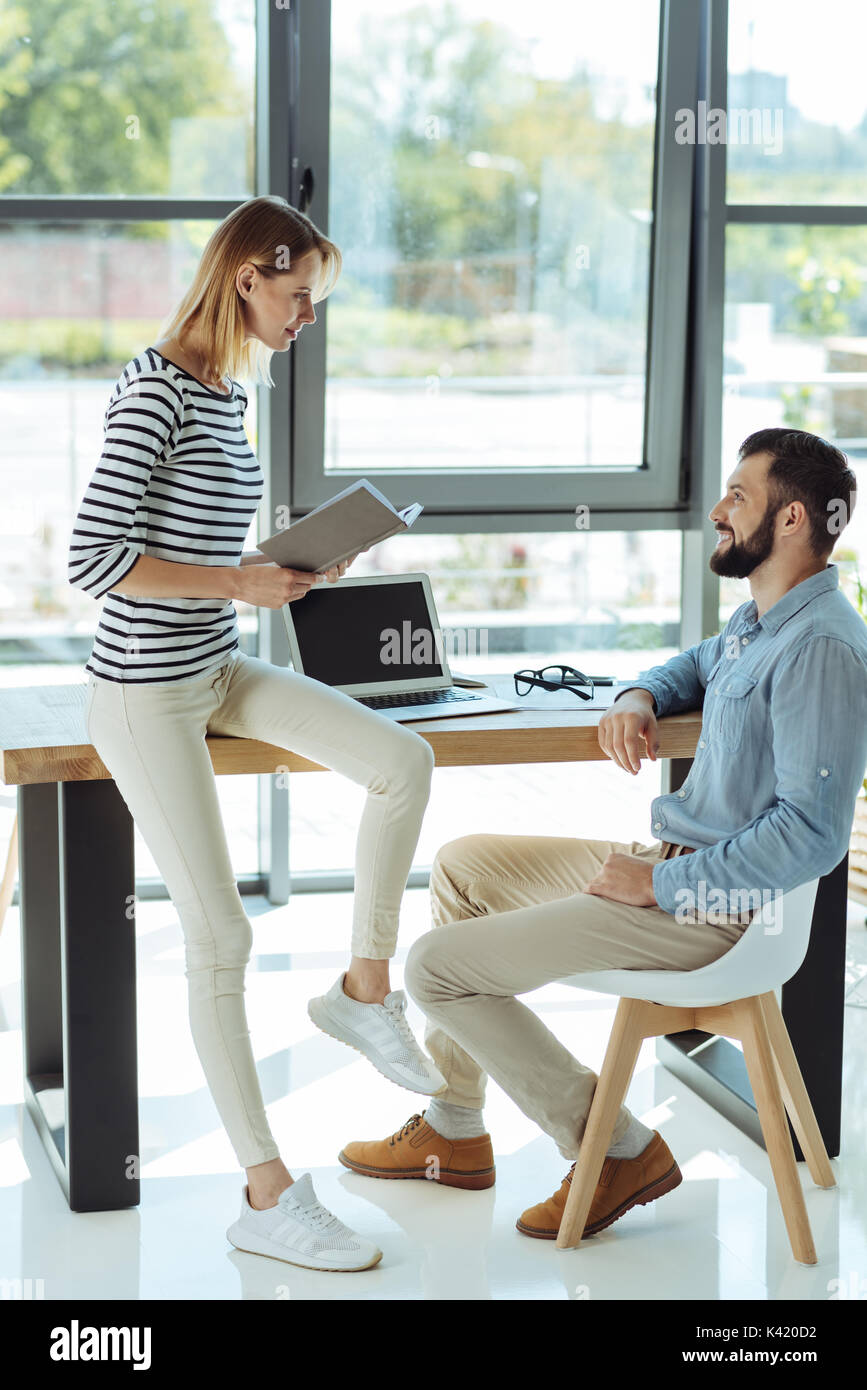 Cheerful colleagues chatting in the office Stock Photo