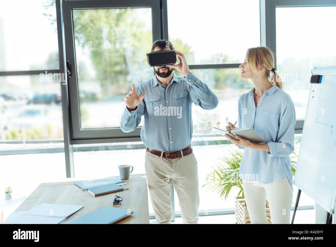 Bearded young man wearing VR headset in the office Stock Photo