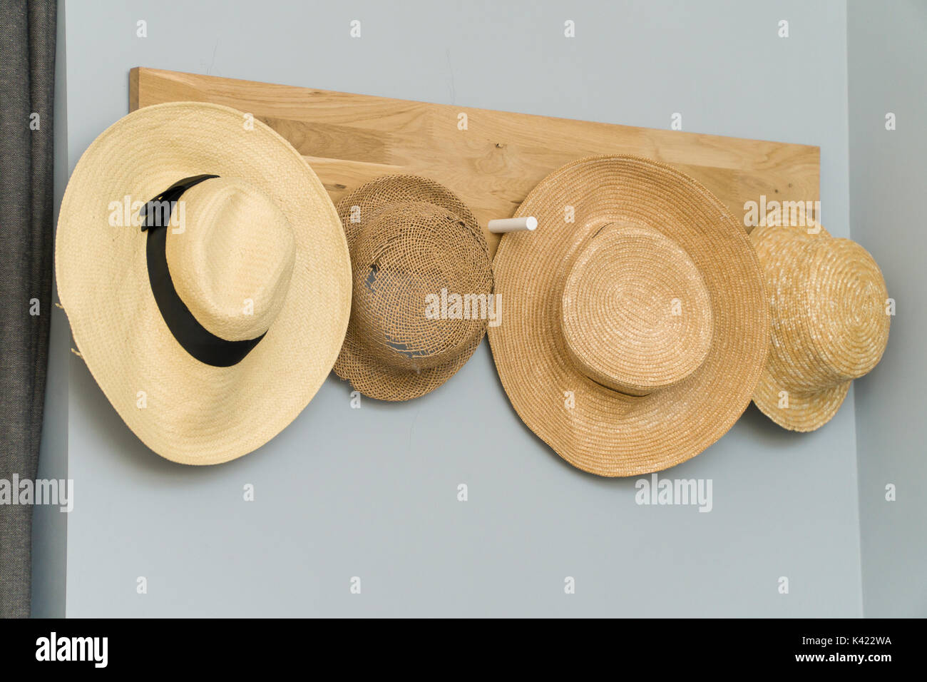 four hats hanging in a wooden wall. Stock Photo