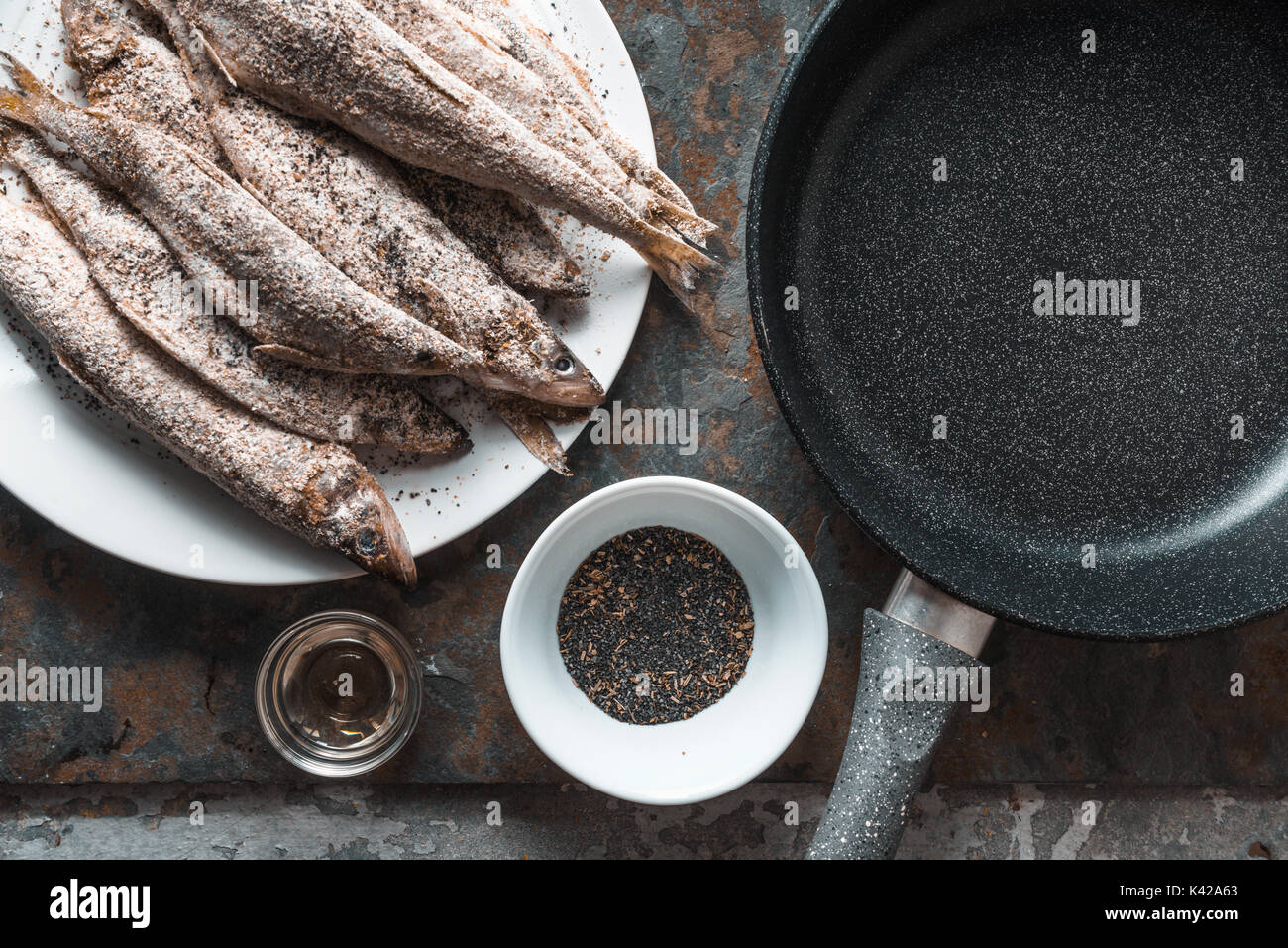 Smelt on a plate, frying pan, salt and spices horizontal Stock Photo