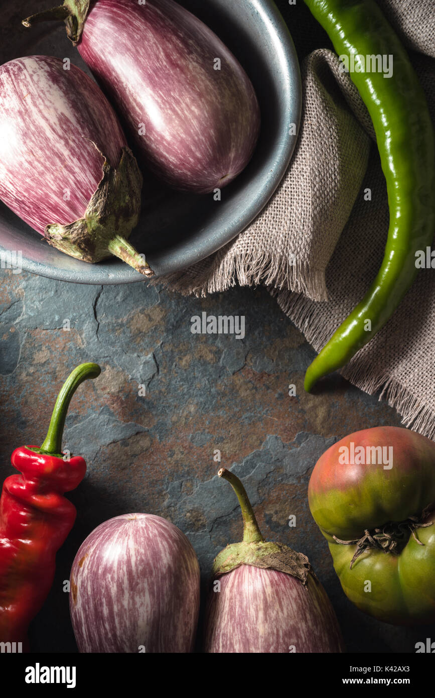 Frame of red and green chili peppers, tomato and eggplant vertical ...