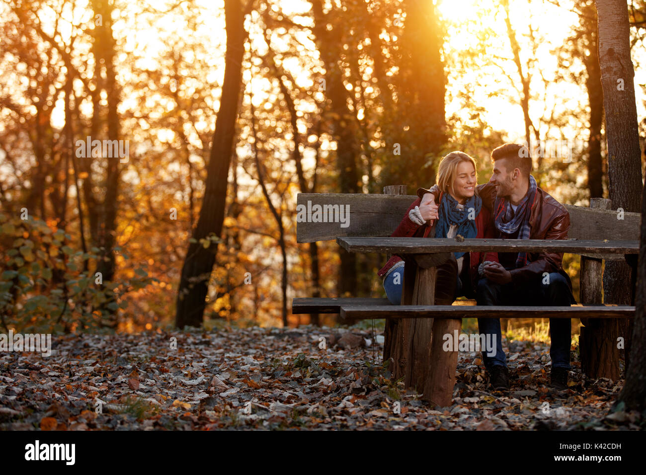 smiling couple in love on bench in the park Stock Photo - Alamy