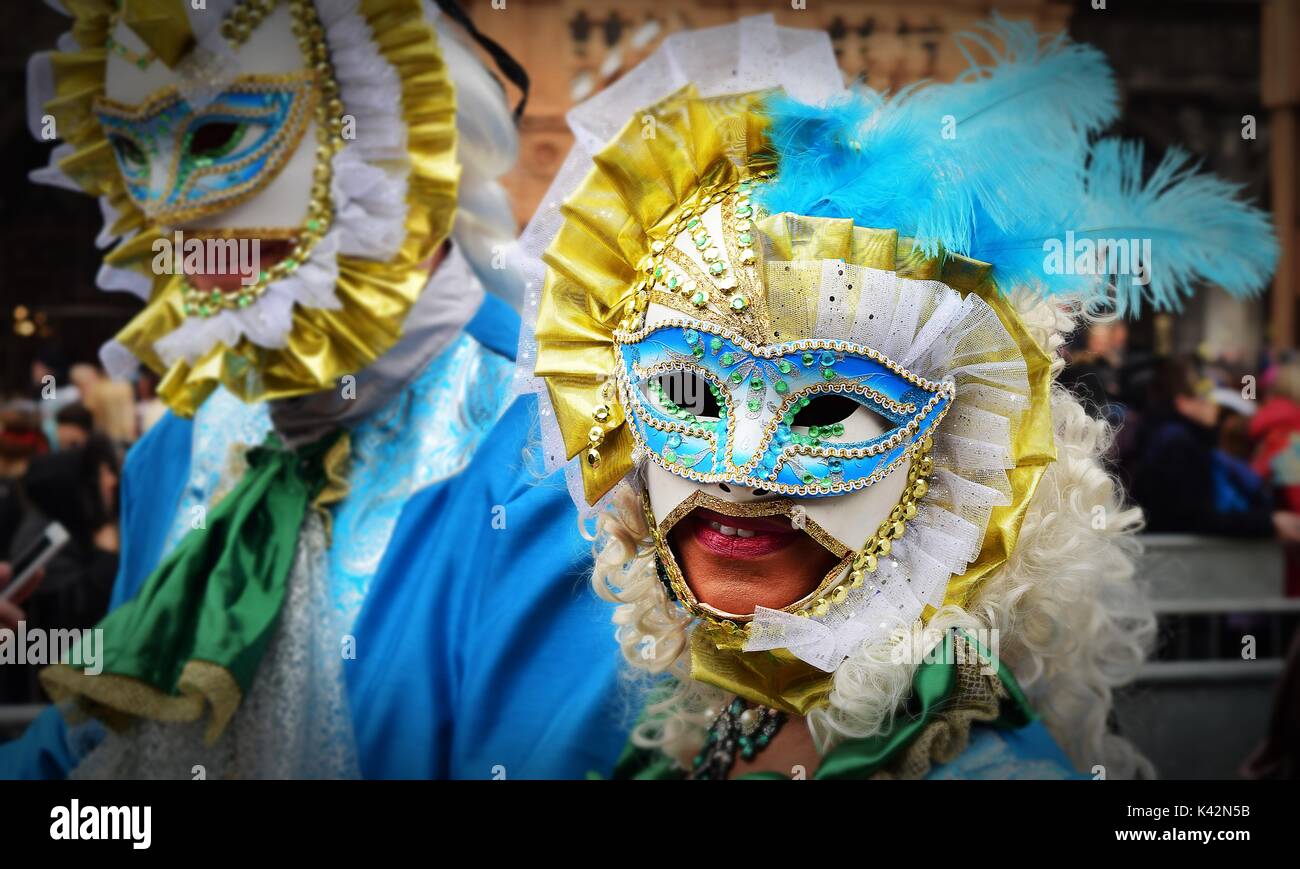 A Venetian masked masquerade in costume at the carnival of Venice Stock Photo