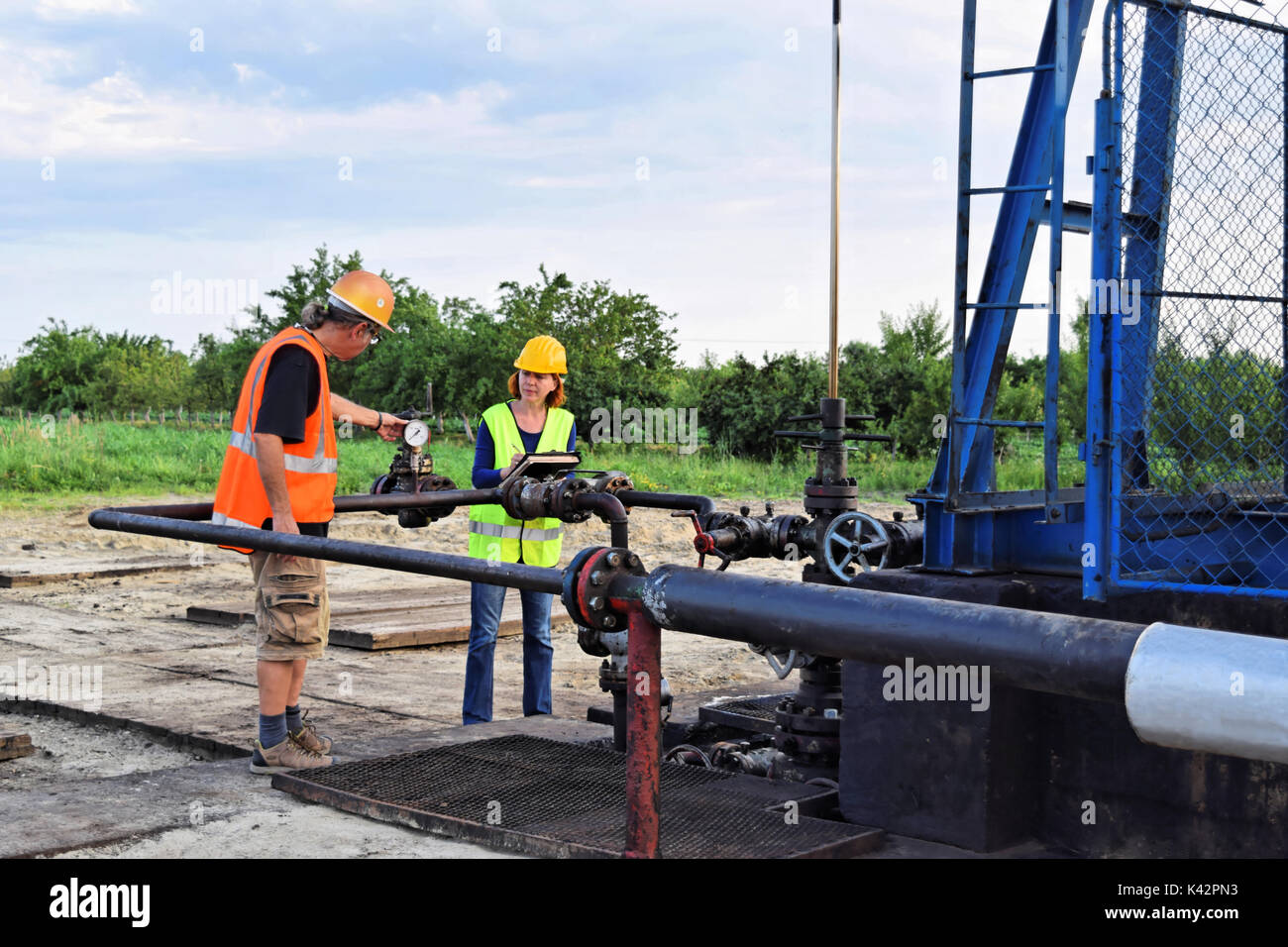 Two petroleum engineers at work on an European oil well Stock Photo