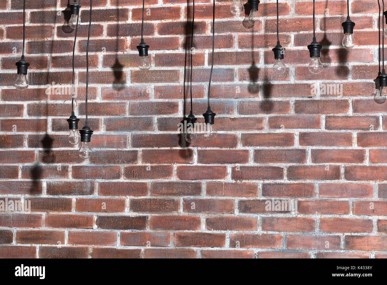 Brick wall with bulb lights lamp. nice brick show room with spotlights. Stock Photo