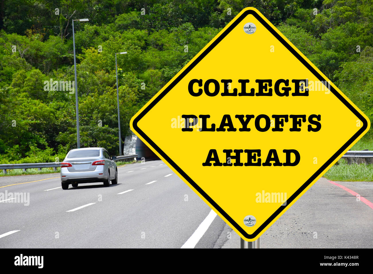 College playoffs ahead, yellow warning road sign Stock Photo