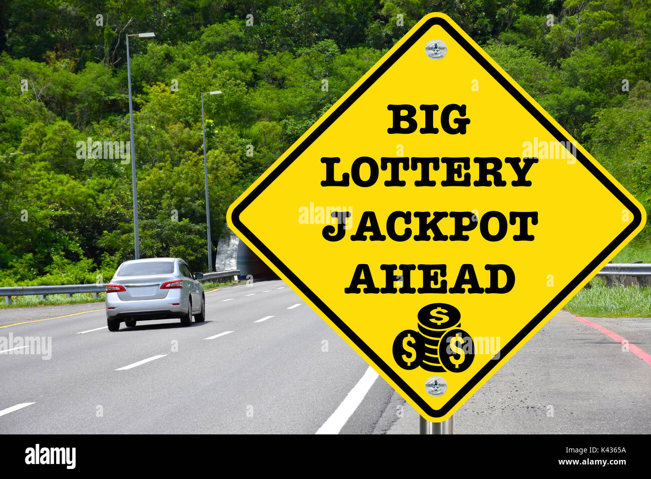 Big lottery jackpot ahead, yellow warning road sign Stock Photo