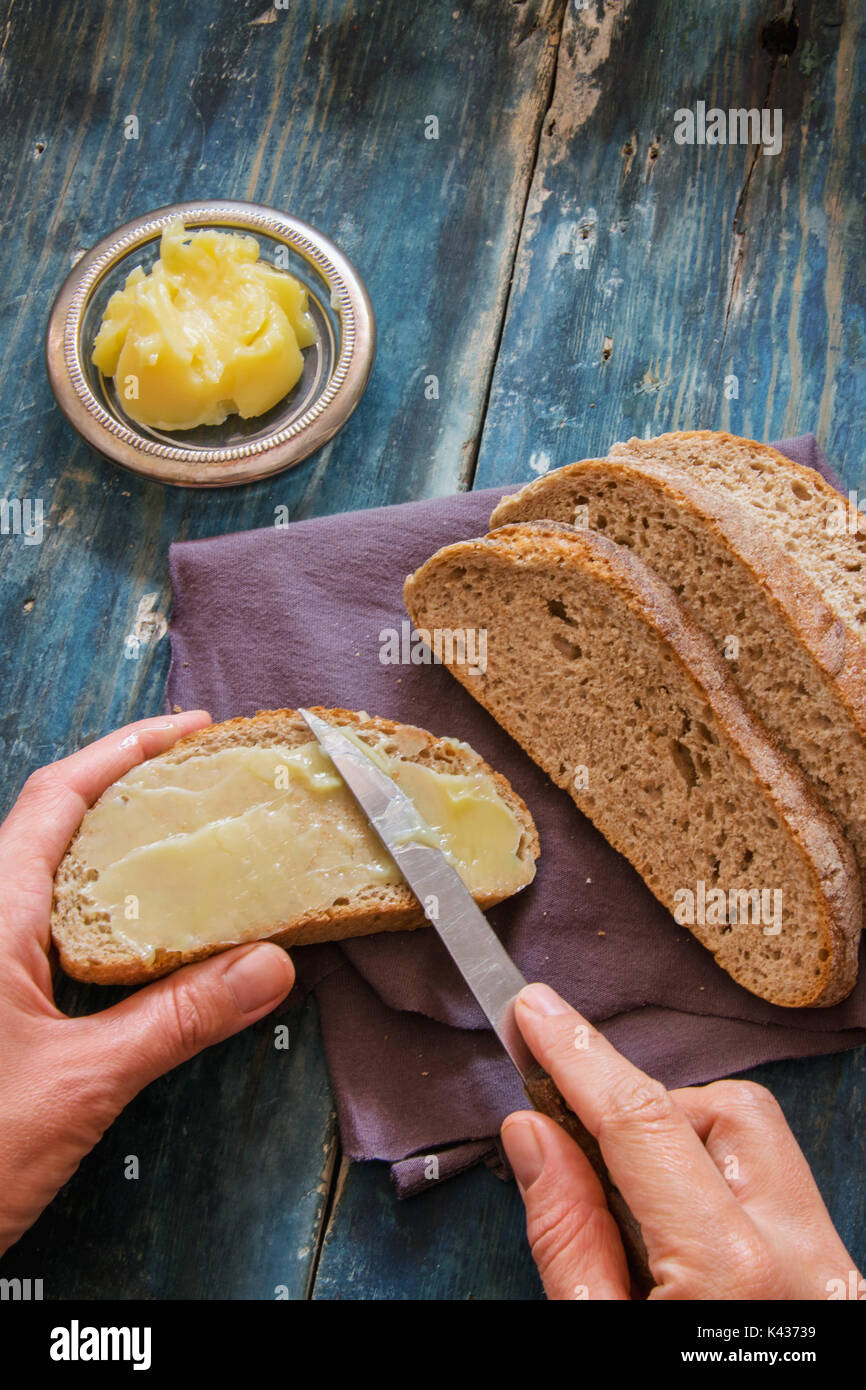 Spread fresh butter on whole wheat bread Stock Photo Alamy