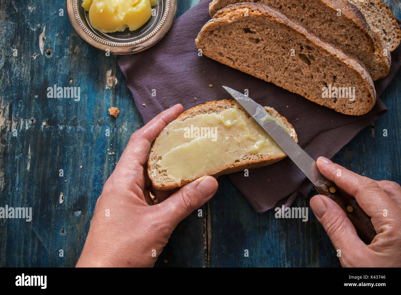 Spread fresh butter on whole wheat bread Stock Photo Alamy