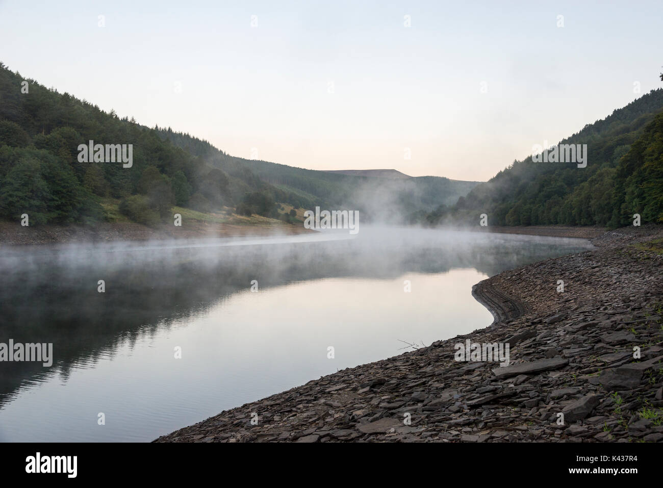 Stunning September morning at Ladybower reservoir, Peak District, Derbyshire, England. Mist drifting over the water surface. Stock Photo