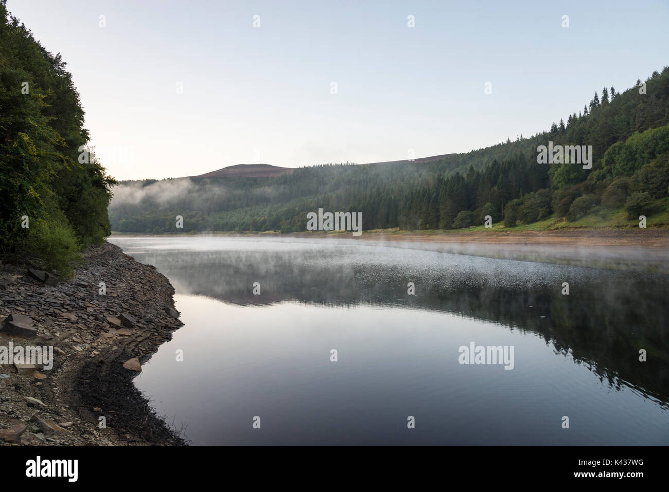 Stunning September morning at Ladybower reservoir, Peak District, Derbyshire, England. Mist drifting over the water surface. Stock Photo