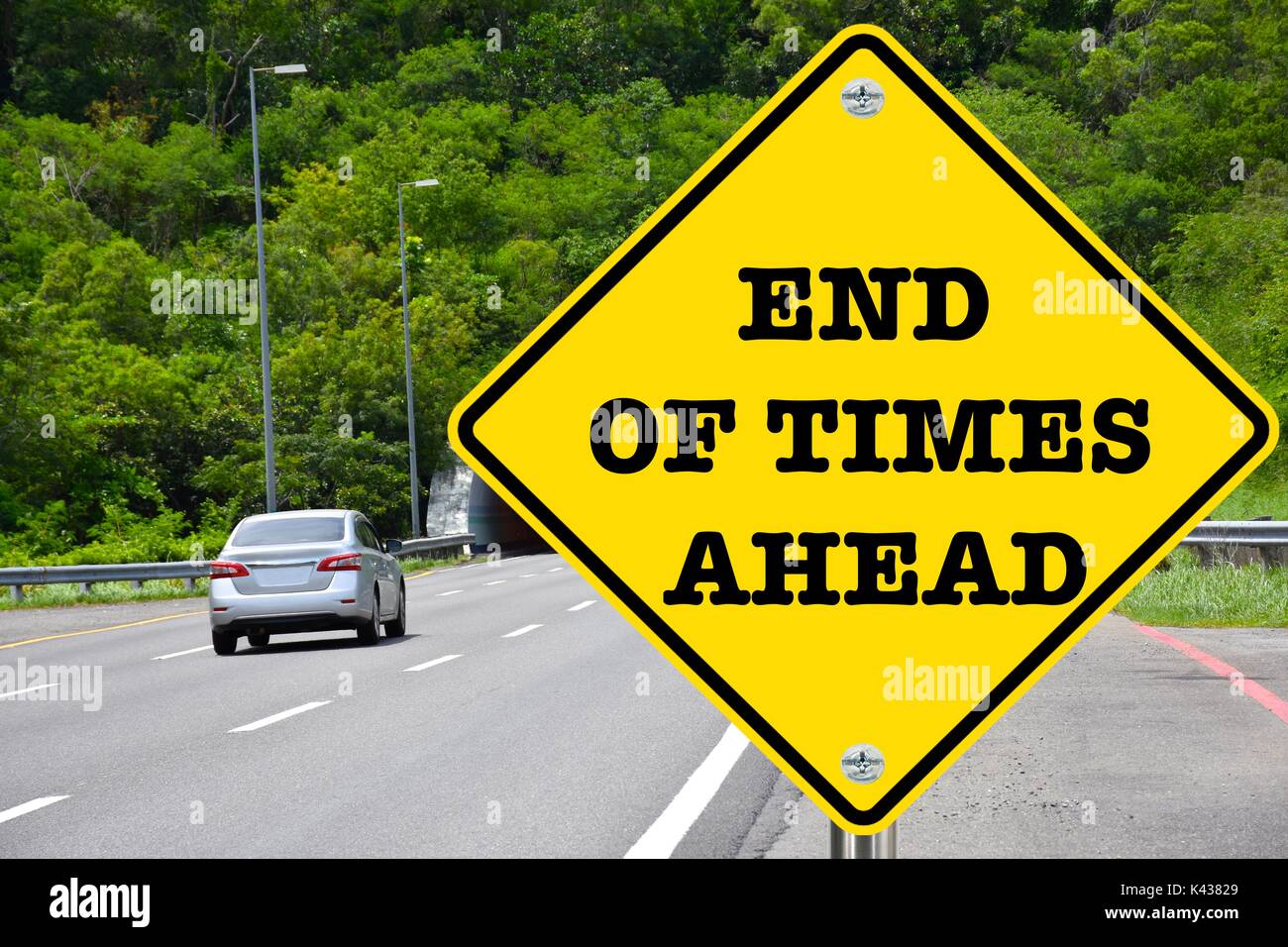 End of times ahead, warning yellow road sign Stock Photo