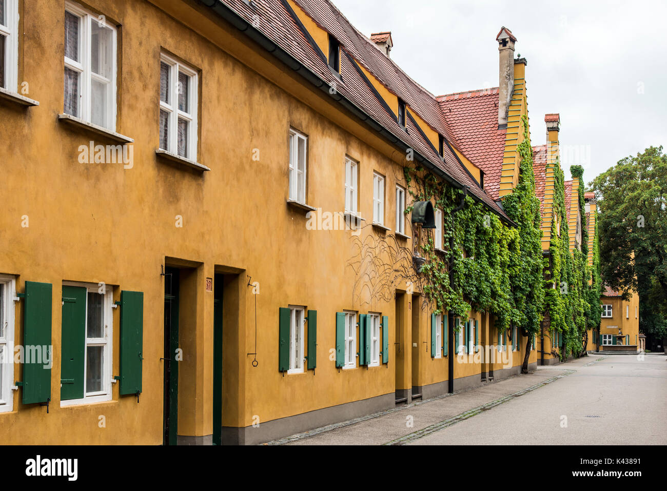 Street view of the Fuggerei settlement, the world's oldest social housing complex still in use, Augsburg, Bavaria, Germany Stock Photo